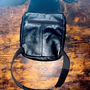 Black leather belt and leg strap purse.